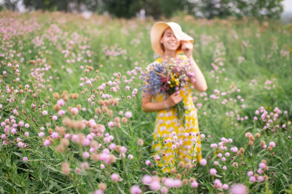 How to Make Your Face Look More Feminine 9 girl in yellow and white floral dress standing on flower field during daytime